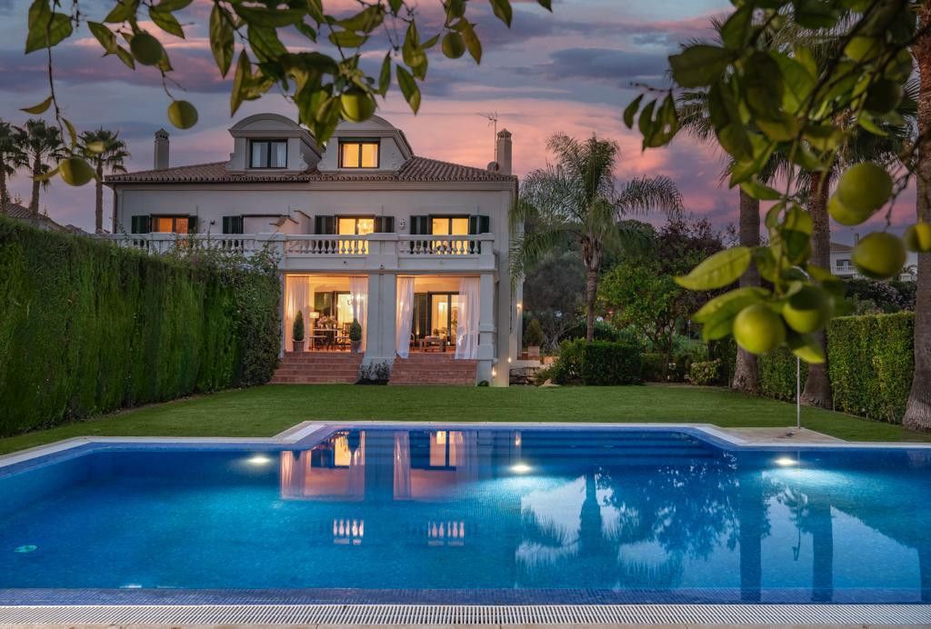 Luxury villa in Sotogrande with a private pool, lush garden, and sunset view.